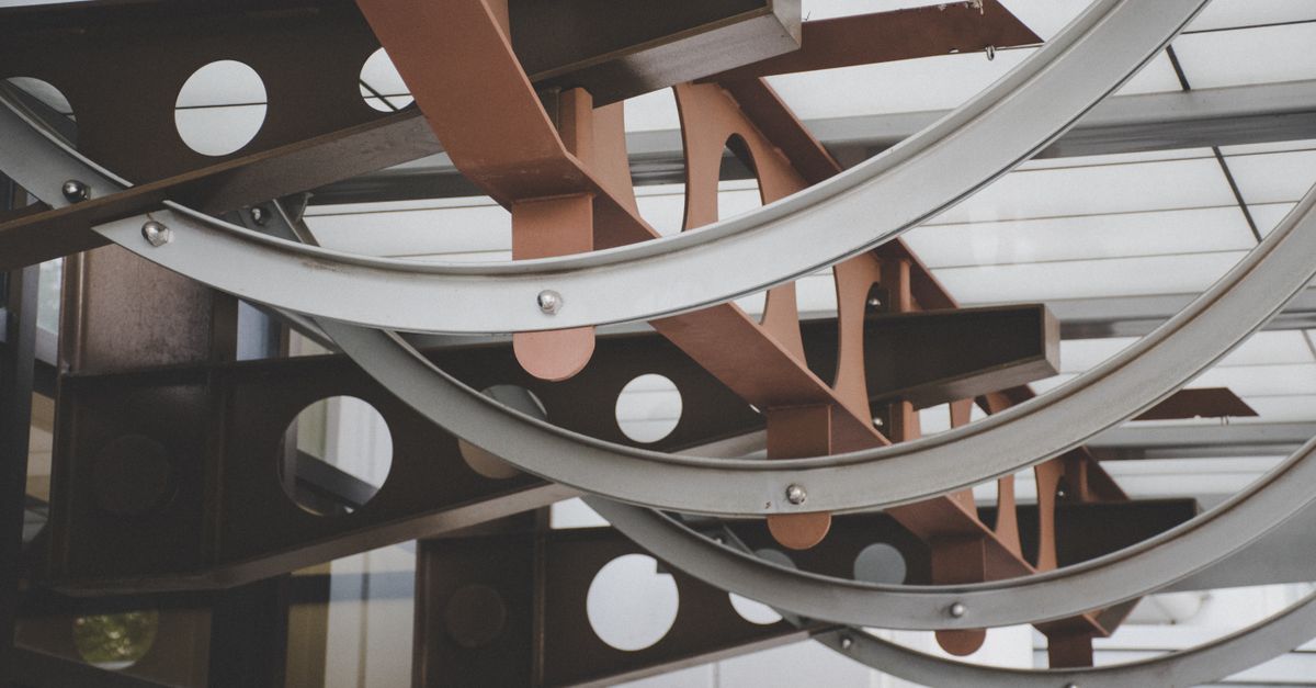 A captivating view of contemporary architectural design with circular metal structures indoors.