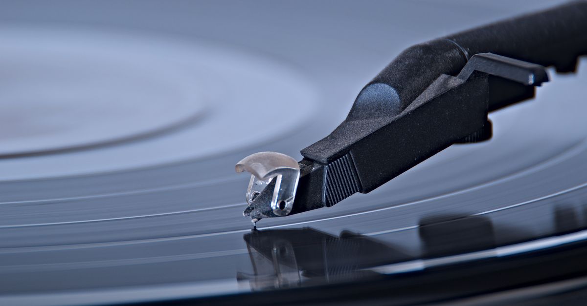 Detailed view of a turntable needle on a spinning vinyl record, capturing the essence of analog music.