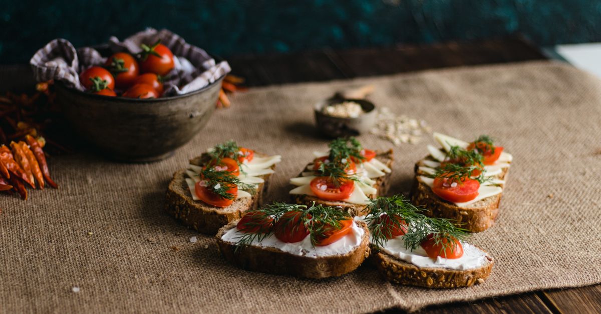 Delicious variety of bread slices with gourmet toppings featuring cheese and tomatoes, shot in Istanbul.