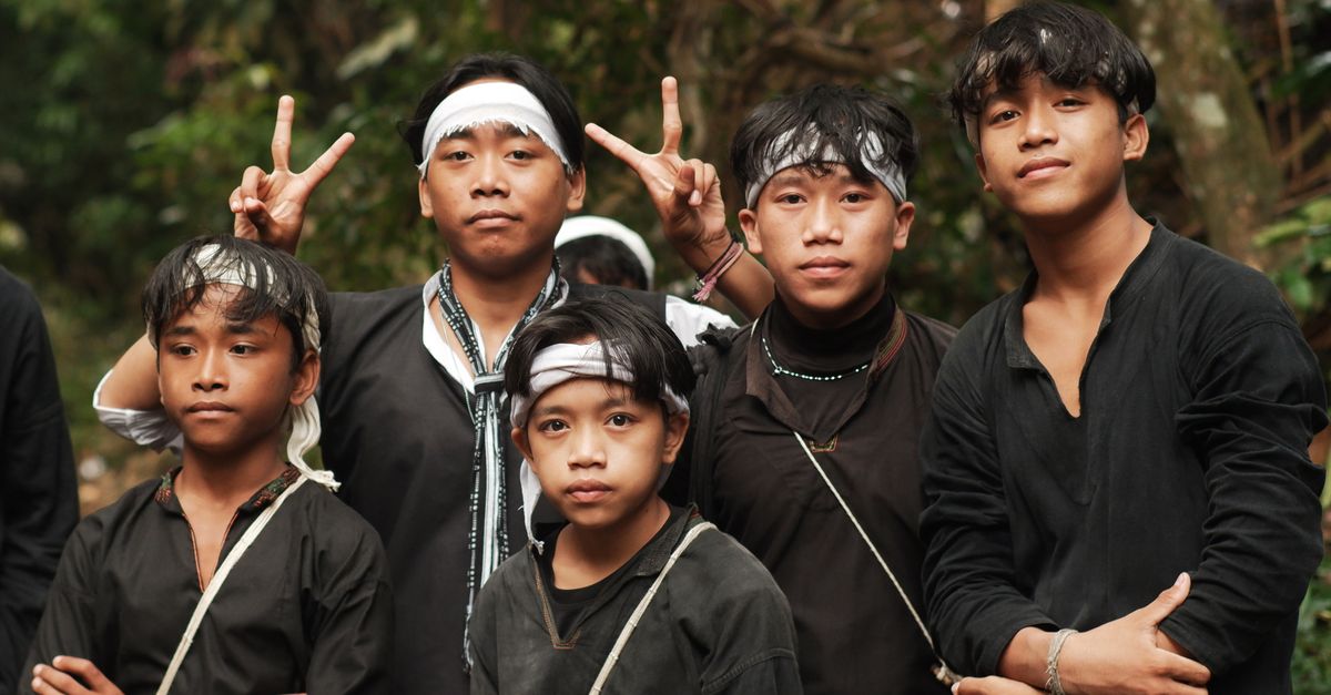 Cultural portrait of a group in traditional attire outdoors in Banten, Indonesia.