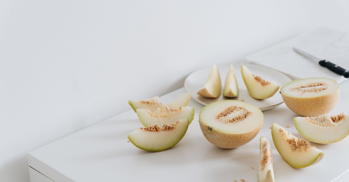 A clean and minimalist setup of freshly sliced melon on a ceramic plate, perfect for healthy eating.