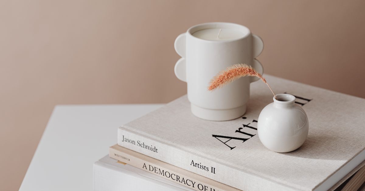 Aesthetic arrangement of books and a vase on a table for minimalist home decor.