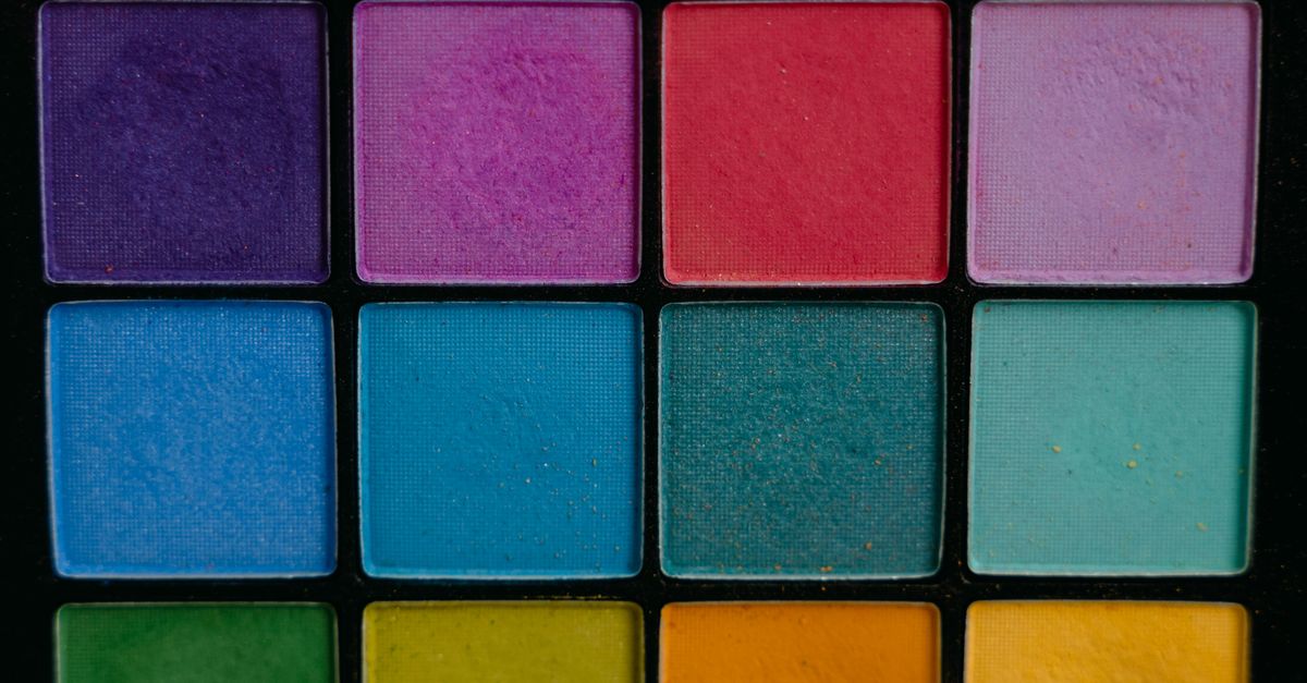 A close-up of a vibrant and colorful eye shadow palette featuring multiple shades, perfect for makeup enthusiasts.