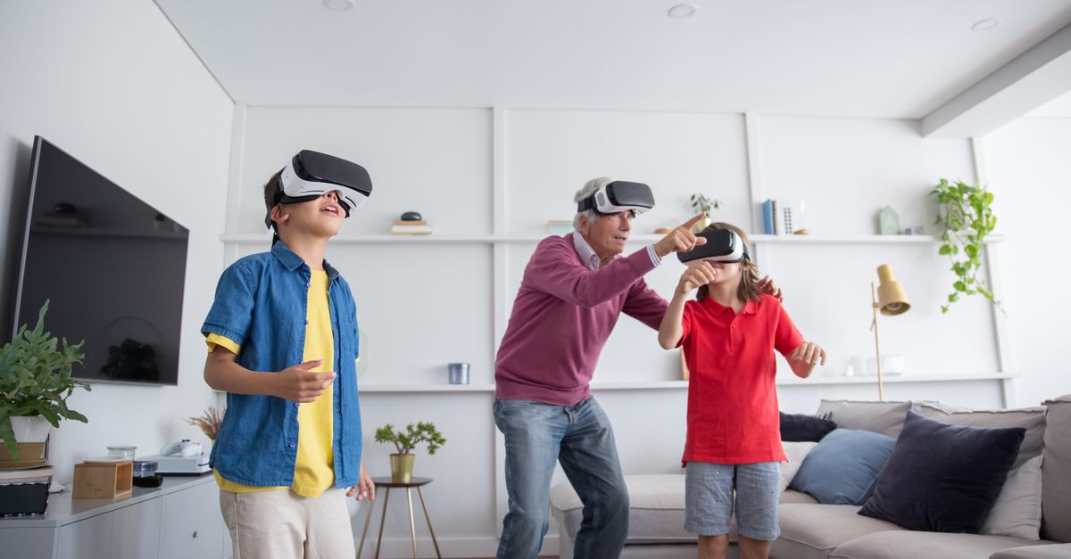 Grandfather and grandchildren bonding over VR gaming in a modern living room.