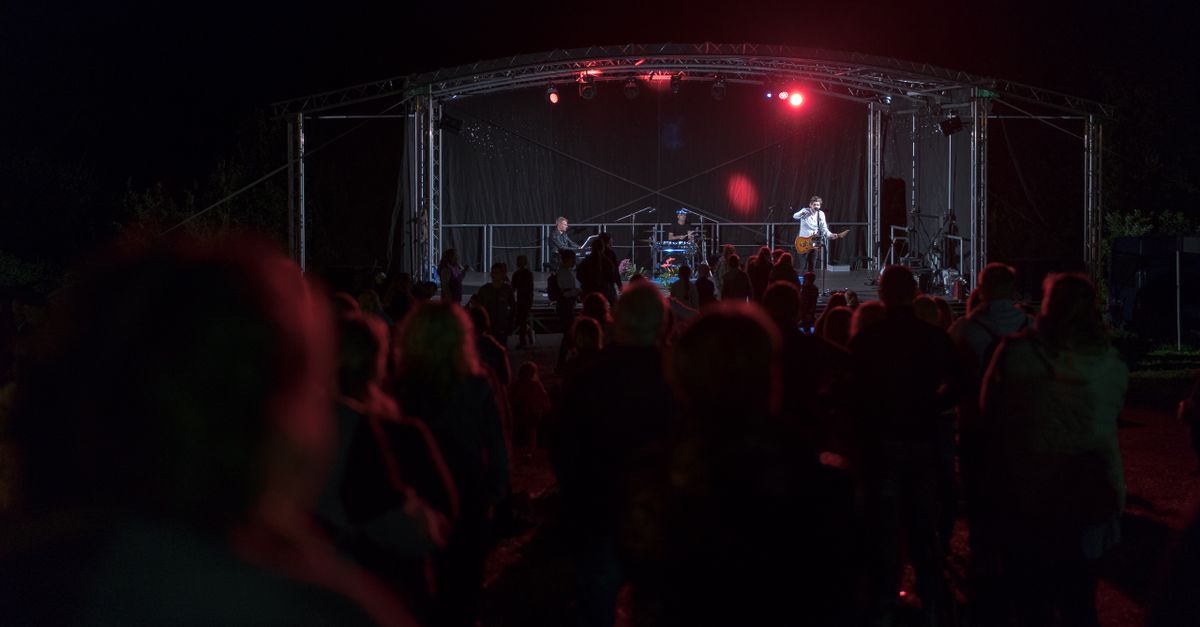 Live music performance at night with a crowd enjoying the concert outdoors in Lithuania.