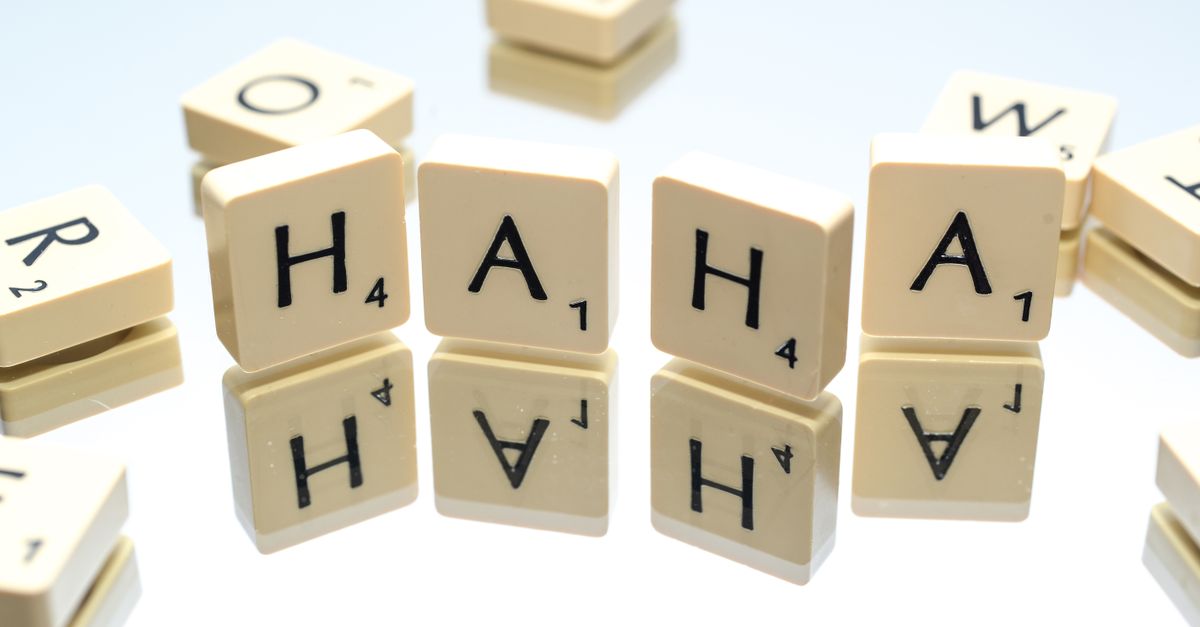 Board game tiles spell out 'HA HA' on a reflective surface, offering a playful concept.